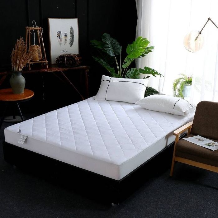 the mattress resting on a bed