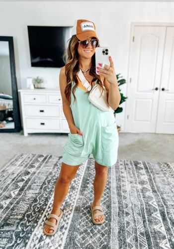 A reviewer in a casual mint-colored romper