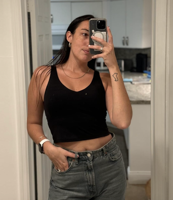 A reviewer wearing a black tank top