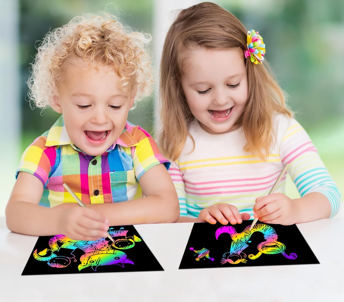 Two child models each drawing on scratch paper with their styluses
