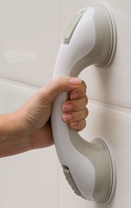 A person gripping onto a handle for support.