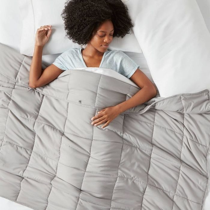 person resting beneath the weighted blanket