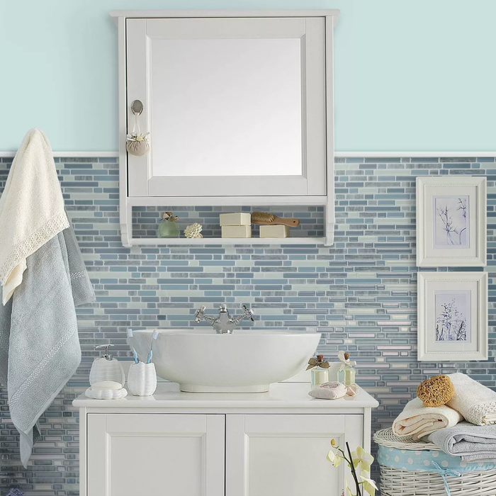 Blue backsplash tiles in a bathroom.