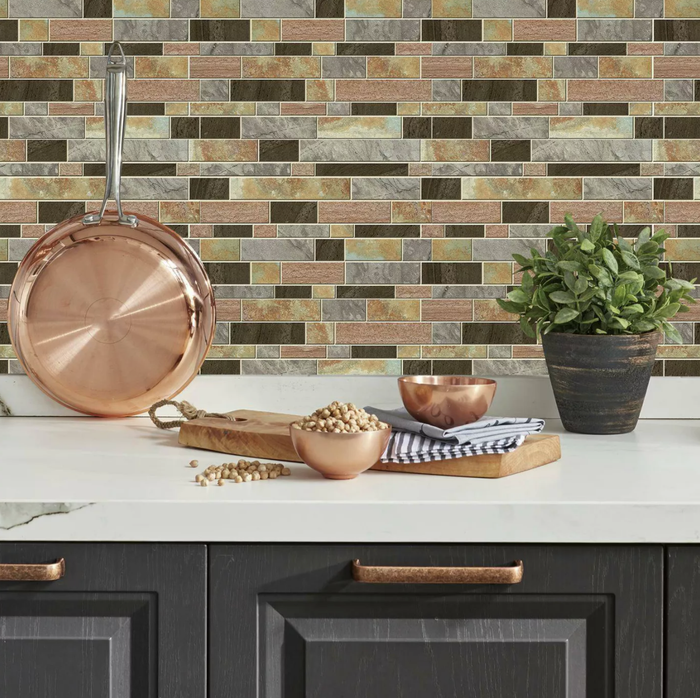 Brown, gray, and black backsplash tiles in a kitchen.