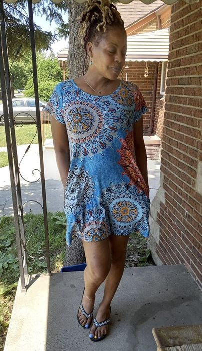 A reviewer wearing the dress with a mandala pattern