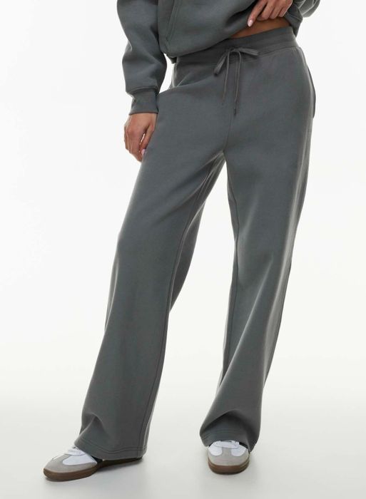 Close-up of a person wearing loose, comfy sweatpants paired with casual sneakers