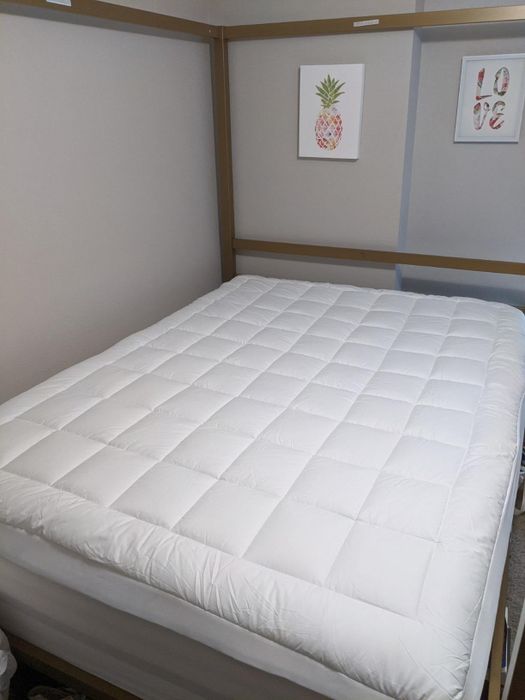 A photo shared by the reviewer of the mattress topper