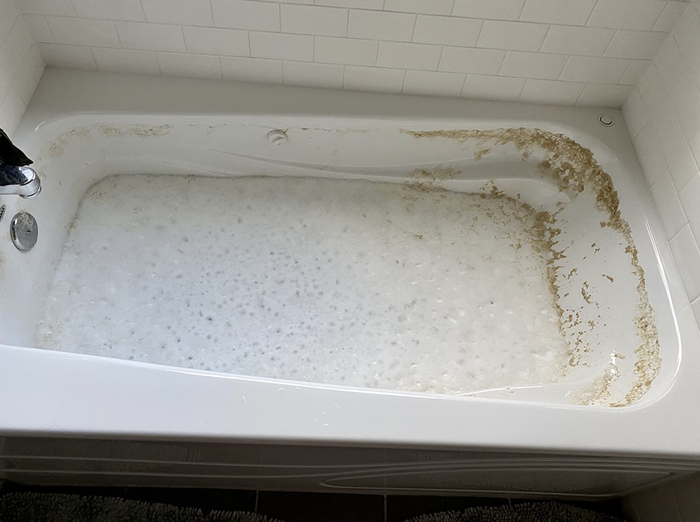A reviewer's jetted tub, being filled with water and cleaner before the cleaning process begins.