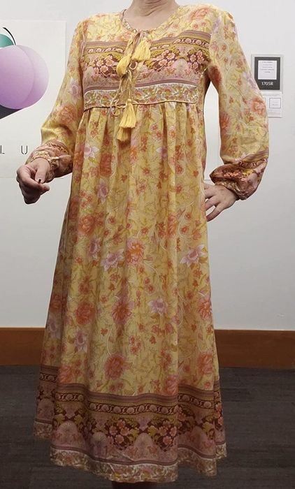 A person wearing the dress in yellow.