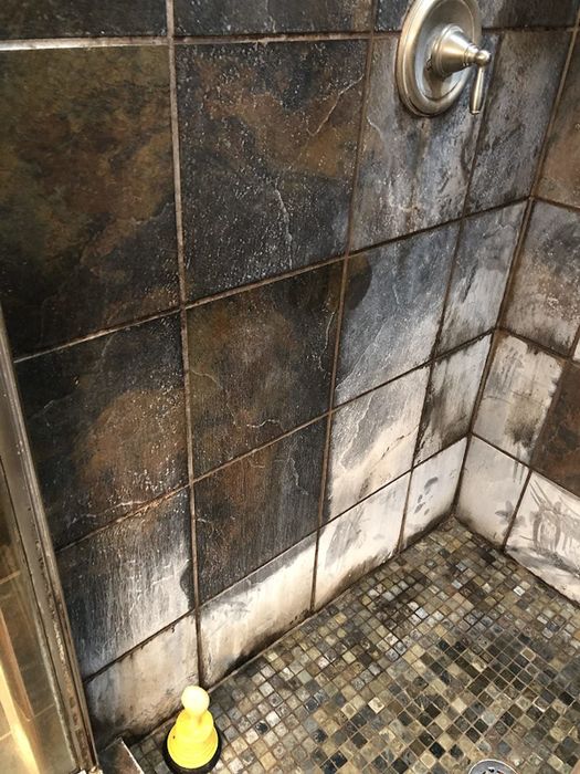 Before image showing a shower with dirty white soap scum on the walls and floor