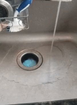 A gif from a reviewer showing the garbage disposal cleaner bubbling up into a blue foam inside their sink