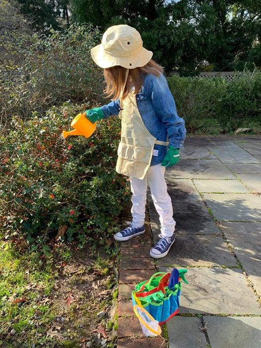 Reviewer image of a child using the gardening set to plant