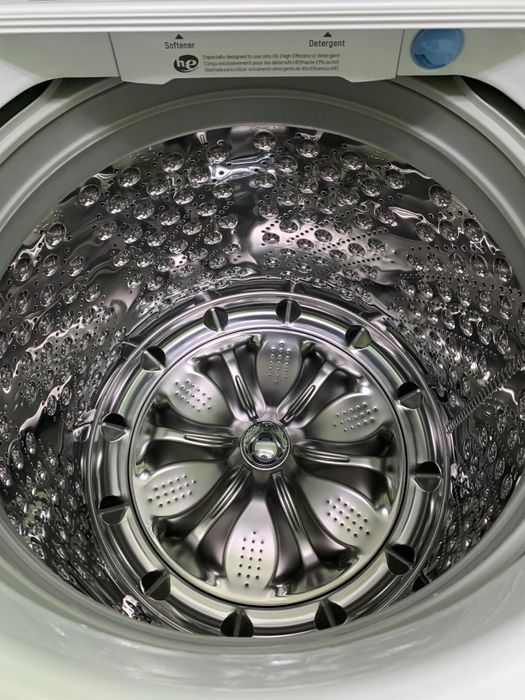 A reviewer image showing a sparkling clean washing machine after using the tablets.