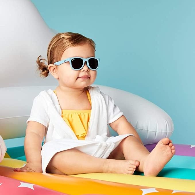 A toddler rocking the blue sunglasses