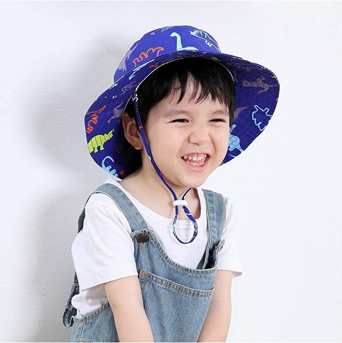 Child model sporting a dinosaur-themed bucket hat