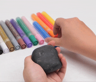 GIF of a person painting a narwhal on a rock