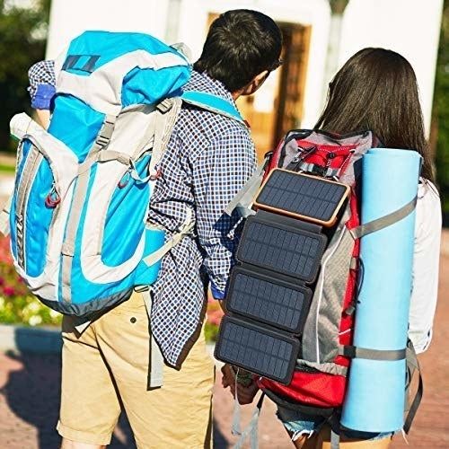 The power bank is hanging from a camper’s backpack, ready for use.
