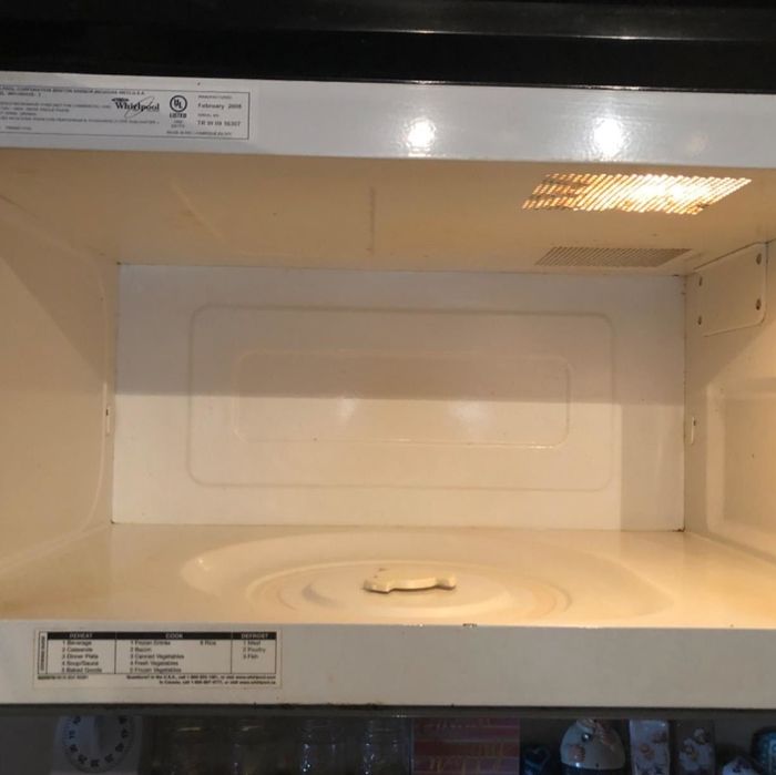 The reviewer's after photo showing a perfectly clean microwave with all spots gone