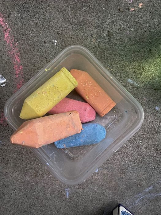A reviewer’s image showing a container filled with large, chunky sidewalk chalk.