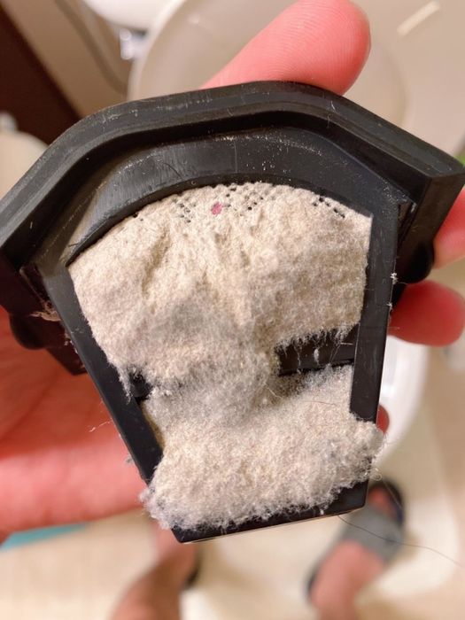 A review photo showing all the dust collected by the mattress vacuum