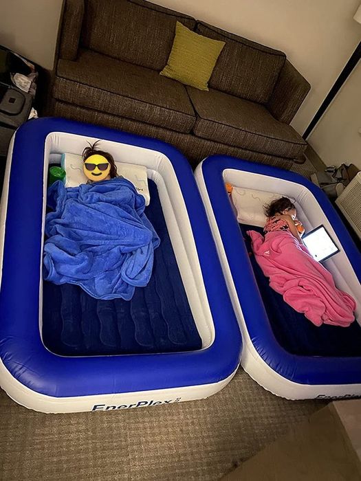 Image of two toddlers happily sleeping in their individual inflatable beds