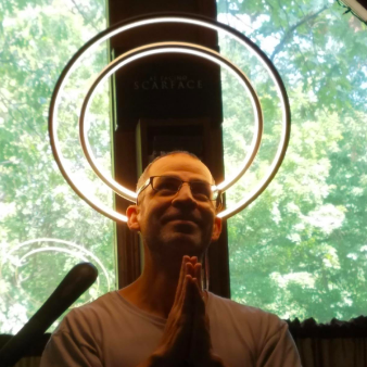 Reviewer with two circle lights above their head, creating the appearance of a halo.