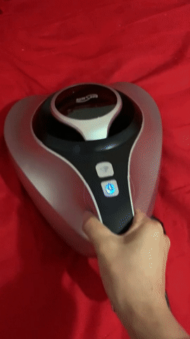 A gif of a reviewer using the mattress vacuum to clean their bed