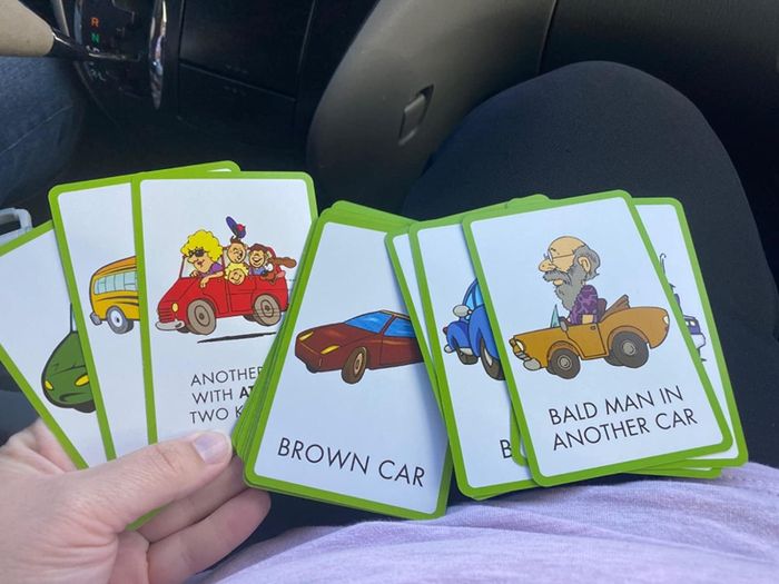 Image of a reviewer holding up multiple scavenger hunt cards