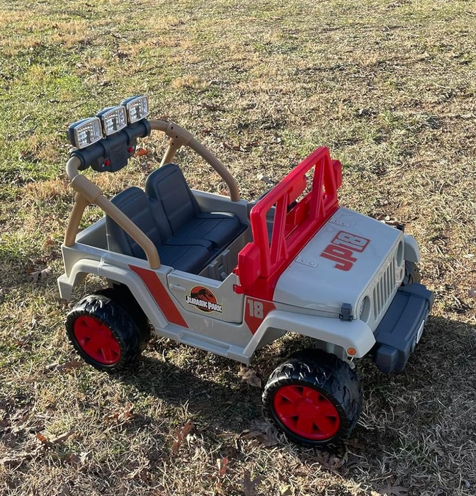 A Jurassic Park-inspired toy Jeep Wrangler parked outside