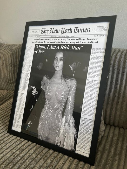 A framed cover of the New York Times showcasing Cher with a quote about independence.