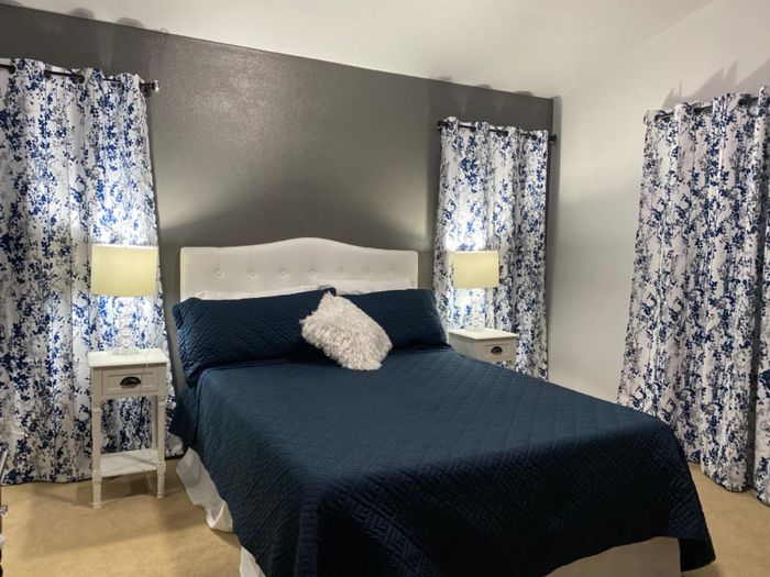 Reviewer's white tufted headboard displayed in their bedroom