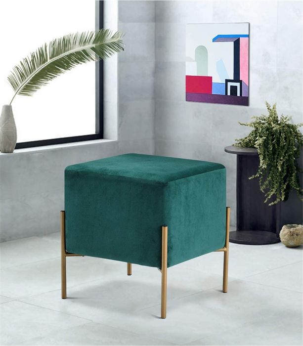 A square velvet ottoman paired with sleek gold leg frames