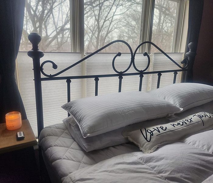 Reviewer's bed displayed with the pillows neatly arranged
