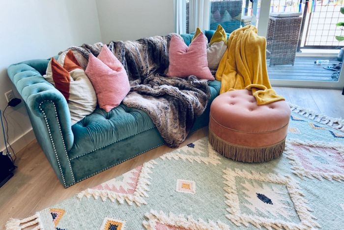 The reviewer's ottoman is displayed in a stylish living room setting.