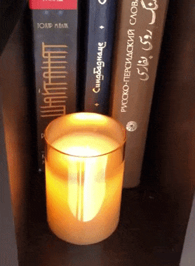 A gif displaying the candle's realistic flicker while resting on a shelf.