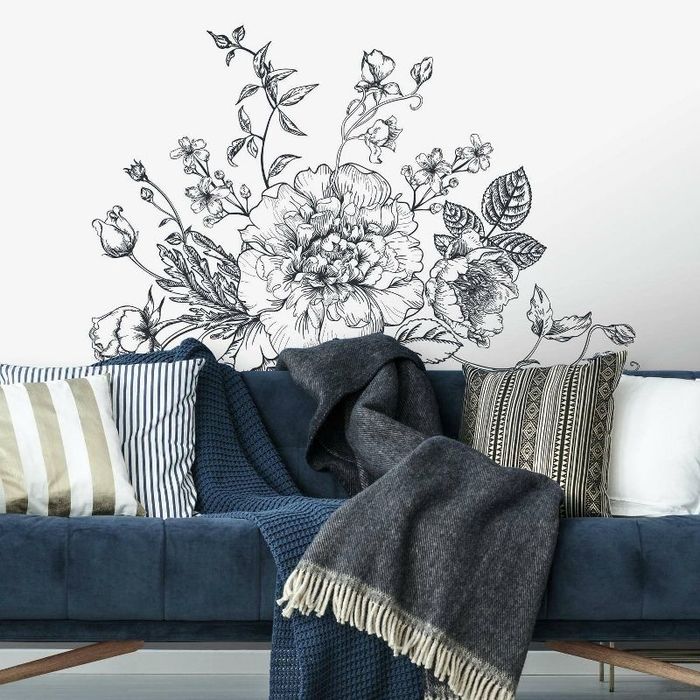The wall decal positioned behind a couch