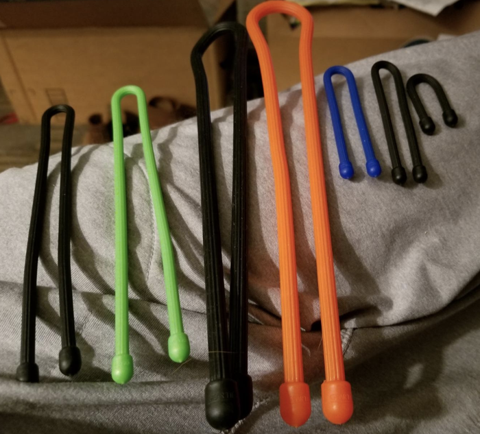 the rubber twist ties come in various sizes and colors including green, black, orange, and blue