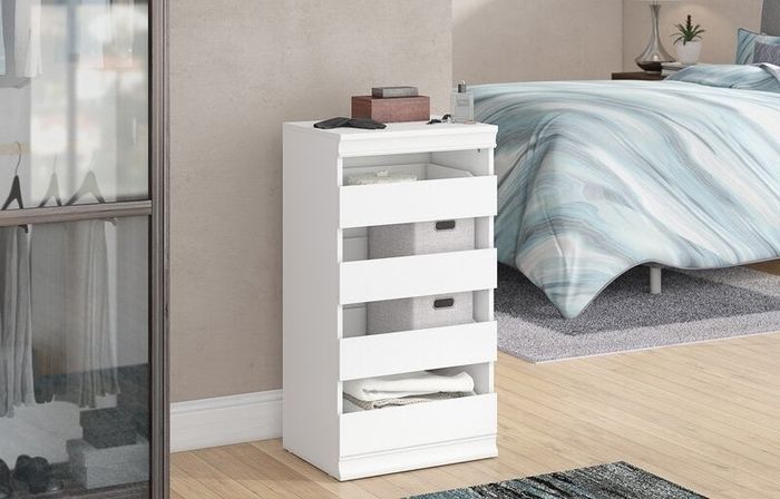 The white drawers neatly placed in a bedroom.