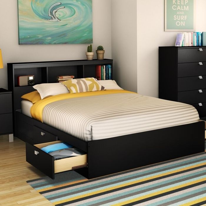 The bed in use, styled with a bookcase headboard for added convenience and charm.
