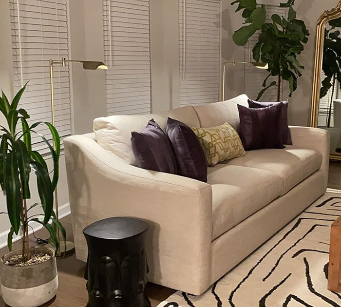 the two lamps placed behind a couch