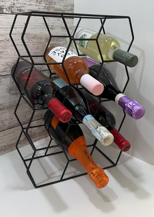 Another reviewer’s black hexagonal wine rack placed on a countertop, displaying multiple wine bottles
