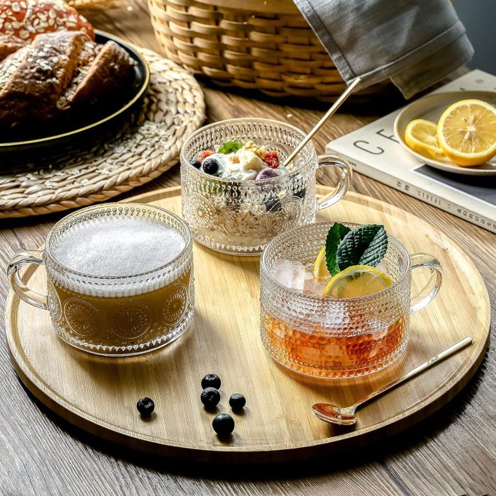 Three vintage embossed glass mugs filled with tea