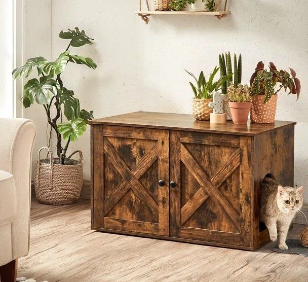 A cat gracefully exits the rustic brown enclosure, which cleverly doubles as an accent table.