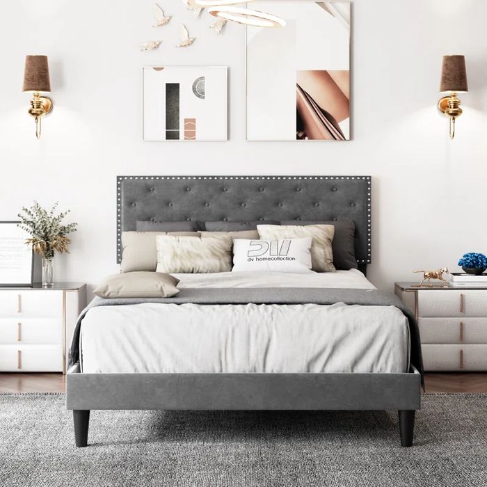 A grey velvet bed gracefully placed in a bedroom setting, exuding sophistication and luxury.