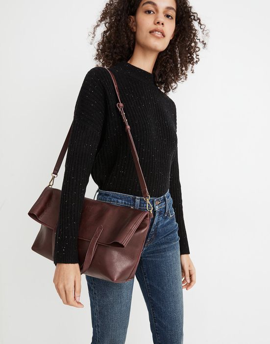 model holding a deep red handbag