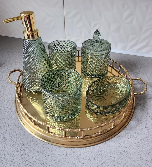 A reviewer’s green bathroom accessory set displayed elegantly on a gold tray
