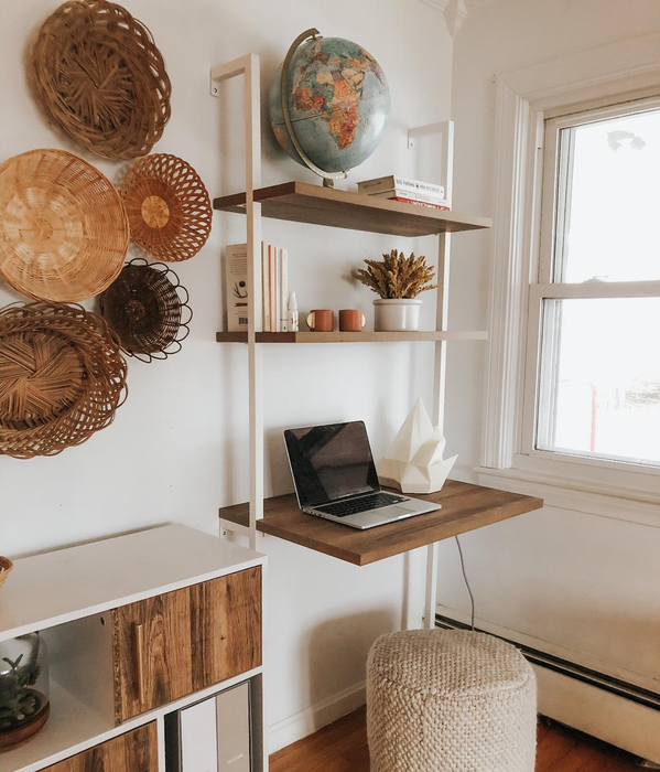 A reviewer's rustic oak and white desk in a cozy office nook