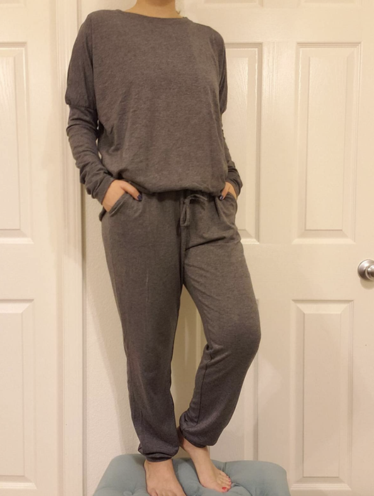 reviewer sporting gray sweatpants and a matching gray crewneck sweater