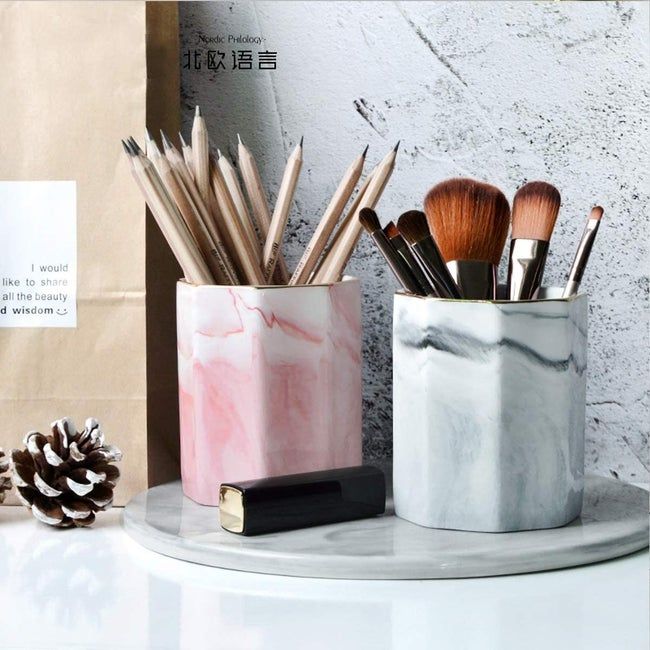 Two pen holders with a marble print design