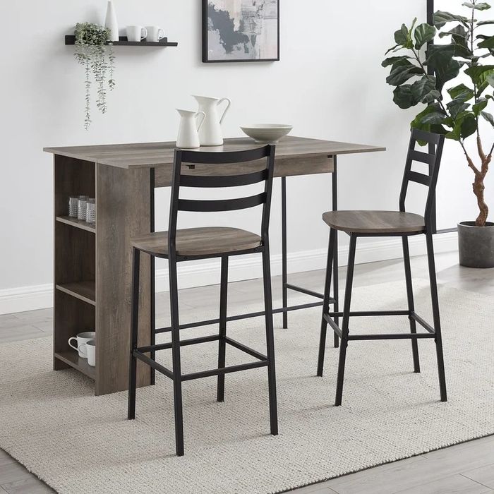 The brown dining set featuring a drop-leaf design in a cozy home setting, with the leaf fully extended for additional space.